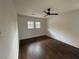 A bright bedroom offers hardwood floors, white walls, a ceiling fan, and plenty of natural light at 1938 Highway 212 Sw, Conyers, GA 30094