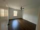This bedroom features gleaming hardwood floors, a ceiling fan, and a bright window at 1938 Highway 212 Sw, Conyers, GA 30094