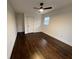Bright bedroom features hardwood floors, a ceiling fan, a closet, and lots of natural light at 1938 Highway 212 Sw, Conyers, GA 30094