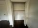 An open closet reveals ample storage space with a wooden rod for hanging clothes at 1938 Highway 212 Sw, Conyers, GA 30094