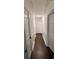 A hallway featuring hardwood floors, paneled walls, and doors leading to other rooms at 1938 Highway 212 Sw, Conyers, GA 30094