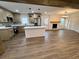 Open floor plan with fireplace, stainless steel appliances, and kitchen island at 1938 Highway 212 Sw, Conyers, GA 30094