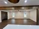Spacious living room featuring hardwood floors, natural light, and wooden support beams at 1938 Highway 212 Sw, Conyers, GA 30094