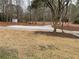 Spacious yard featuring a gravel area and convenient shed in a wooded area at 1938 Highway 212 Sw, Conyers, GA 30094