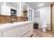 Modern bathroom with double vanity, mosaic tile, and walk-in shower at 3812 Stonewall Se Ter, Atlanta, GA 30339