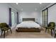 Main bedroom with large bed, two chairs, and sliding barn door at 3812 Stonewall Se Ter, Atlanta, GA 30339