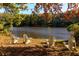 Four Adirondack chairs by the lake, enjoying autumn colors at 3812 Stonewall Se Ter, Atlanta, GA 30339