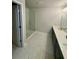 Modern bathroom features double vanity and glass-enclosed shower with marble-like tile surround at 3990 Cavalier Way, Duluth, GA 30097
