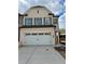 Charming two-story home featuring a two-car garage and attractive window shutters at 3990 Cavalier Way, Duluth, GA 30097