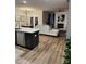 Open concept living area with a kitchen island, fireplace, and comfortable seating arrangement at 3990 Cavalier Way, Duluth, GA 30097