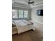 Bright and airy primary bedroom with a large bed, three windows, and a ceiling fan at 3990 Cavalier Way, Duluth, GA 30097