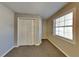 Well-lit bedroom with double-door closet and window at 1019 Braelin Ct, Woodstock, GA 30189