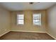 Simple bedroom with two windows and neutral wall color at 1019 Braelin Ct, Woodstock, GA 30189