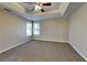 Bright bedroom featuring carpet, ceiling fan and multiple windows at 1019 Braelin Ct, Woodstock, GA 30189