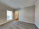 Bright living room with neutral walls and carpeting, view of entryway at 1019 Braelin Ct, Woodstock, GA 30189