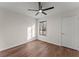 Simple bedroom with hardwood floors and large window at 3920 Stone Creek Cir, Cumming, GA 30041