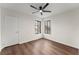 Bright bedroom featuring wood flooring and ceiling fan at 3920 Stone Creek Cir, Cumming, GA 30041