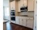 Kitchen features double ovens, gas cooktop and white cabinets at 7179 Linden Dr, South Fulton, GA 30349