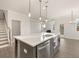 Kitchen island with gray cabinets and stainless steel dishwasher at 7179 Linden Dr, South Fulton, GA 30349