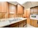 Basement kitchenette with wood cabinets and appliances at 882 Edgewater Trl, Atlanta, GA 30328