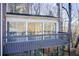 Spacious deck attached to sunroom addition with wooded views at 882 Edgewater Trl, Atlanta, GA 30328