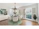 Bright dining room with hardwood floors, chandelier, and view to backyard at 882 Edgewater Trl, Atlanta, GA 30328