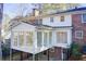 Back exterior showcasing a large sunroom addition and deck at 882 Edgewater Trl, Atlanta, GA 30328