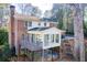 Brick house with sunroom and deck, nestled in a wooded setting at 882 Edgewater Trl, Atlanta, GA 30328