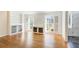 Living room with hardwood floors, built-in shelving, and large windows at 882 Edgewater Trl, Atlanta, GA 30328