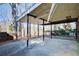 Covered patio with concrete flooring, offering a shaded outdoor space at 882 Edgewater Trl, Atlanta, GA 30328