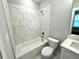 Clean bathroom with marble tile, shower/tub combo and toilet at 1031 Robert Smalls Way, Atlanta, GA 30318