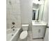 Modern bathroom with marble tile, white vanity, and bathtub at 1031 Robert Smalls Way, Atlanta, GA 30318