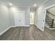 Bright bedroom with wood-look floors and access to bathroom and stairs at 1031 Robert Smalls Way, Atlanta, GA 30318