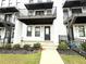 Townhouse front entrance with private patio and landscaping at 1031 Robert Smalls Way, Atlanta, GA 30318