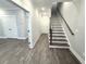 Bright hallway with wood-look flooring, leading to stairs and rooms at 1031 Robert Smalls Way, Atlanta, GA 30318