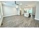 Open living room showcasing hardwood floors and modern kitchen with island at 1031 Robert Smalls Way, Atlanta, GA 30318