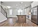 Modern kitchen with two-toned cabinetry, granite island, and stainless steel appliances at 2071 Glenview Park Cir, Duluth, GA 30097