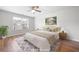 Staged bedroom featuring hardwood floors, a ceiling fan, a window, and a neutral color scheme at 4116 Mars Bay # 27, Acworth, GA 30101