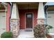 Inviting front entrance with a dark wood door and stone pillars at 4116 Mars Bay # 27, Acworth, GA 30101