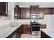 Charming kitchen featuring stainless steel appliances, granite countertops, and dark wood cabinets at 4116 Mars Bay # 27, Acworth, GA 30101