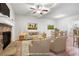 Inviting living room showcasing a stone fireplace, ceiling fan, and hardwood floors next to a dining area at 4116 Mars Bay # 27, Acworth, GA 30101