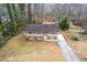 Ranch-style home with driveway, situated on a wooded lot near a river at 900 Sage Nw Ln, Conyers, GA 30012