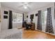 Cozy bedroom with a workspace, wood floors, and black and white curtains at 900 Sage Nw Ln, Conyers, GA 30012