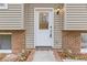 Front door entry, showing a white door and brick accents at 900 Sage Nw Ln, Conyers, GA 30012