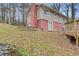 Two-story house with red brick and beige siding, steps leading to the backyard at 900 Sage Nw Ln, Conyers, GA 30012