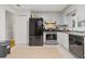 Kitchen with stainless steel appliances and light grey cabinets at 900 Sage Nw Ln, Conyers, GA 30012