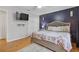 Main bedroom with king-size bed and a navy blue accent wall at 900 Sage Nw Ln, Conyers, GA 30012