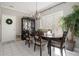 Charming dining room features tiled flooring, large windows, and an elegant chandelier at 102 Prestwick S Way, Stockbridge, GA 30281