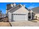 Charming home boasts a wide driveway, attached garage, and inviting front porch with decorative columns at 102 Prestwick S Way, Stockbridge, GA 30281