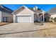 Charming home boasts a well-manicured lawn, a two-car garage, and a stucco exterior at 102 Prestwick S Way, Stockbridge, GA 30281